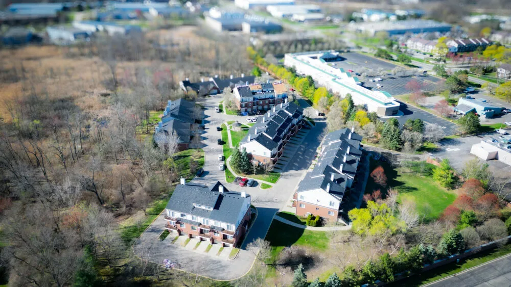 Drone view of finished architectural-shingle roofs on condos by R&R 360