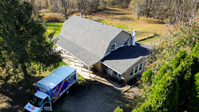 Drone view of completed gambrel-style roof and R&R 360 service truck at rural Howell, MI home
